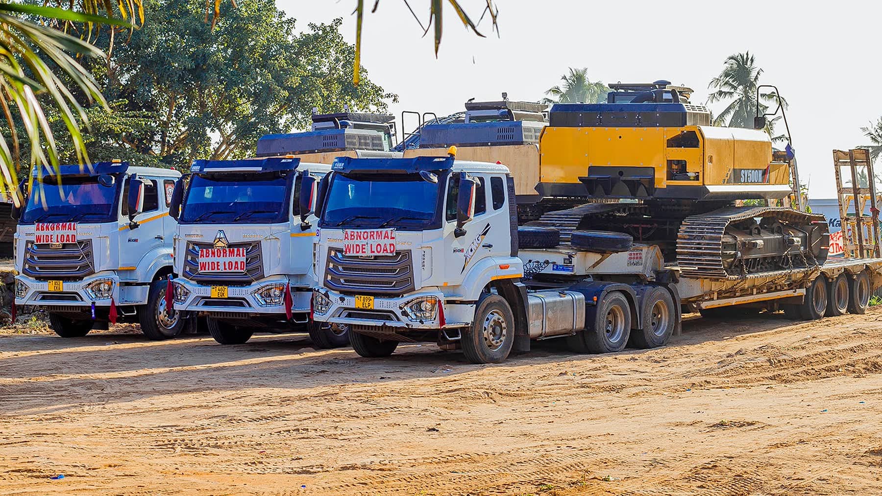 Ellyz prime movers and a loaded lowbed trailer in the yard