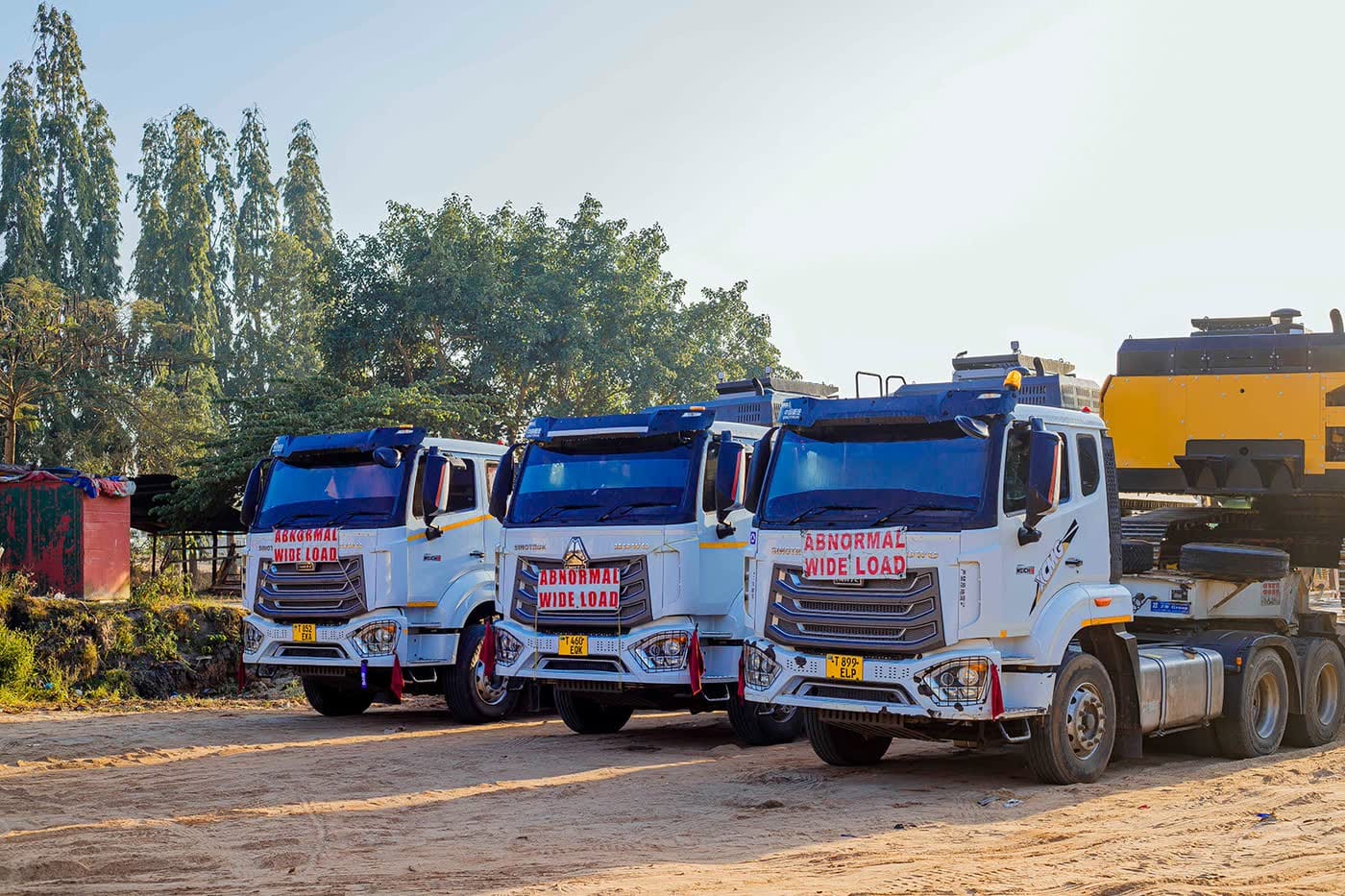 Ellyz prime movers with lowbed trailers staged for heavy equipment transport