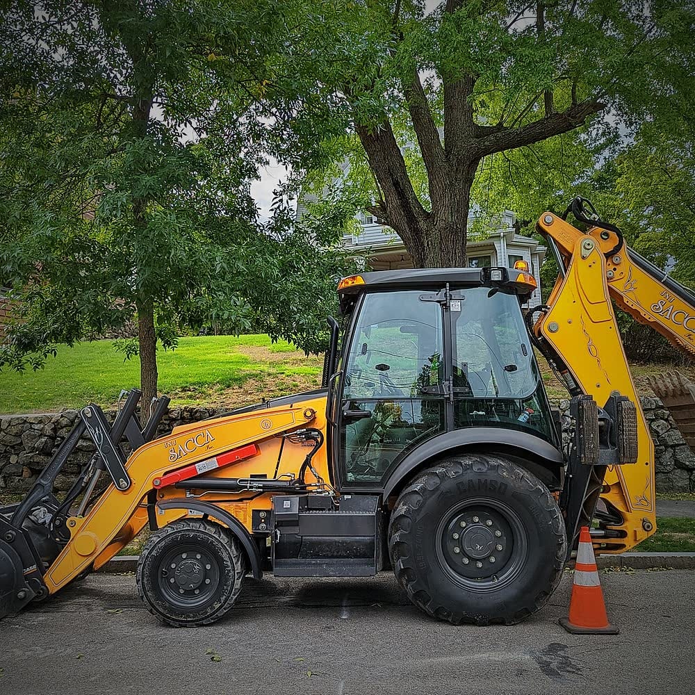 Backhoe loader with front bucket and rear digging arm
