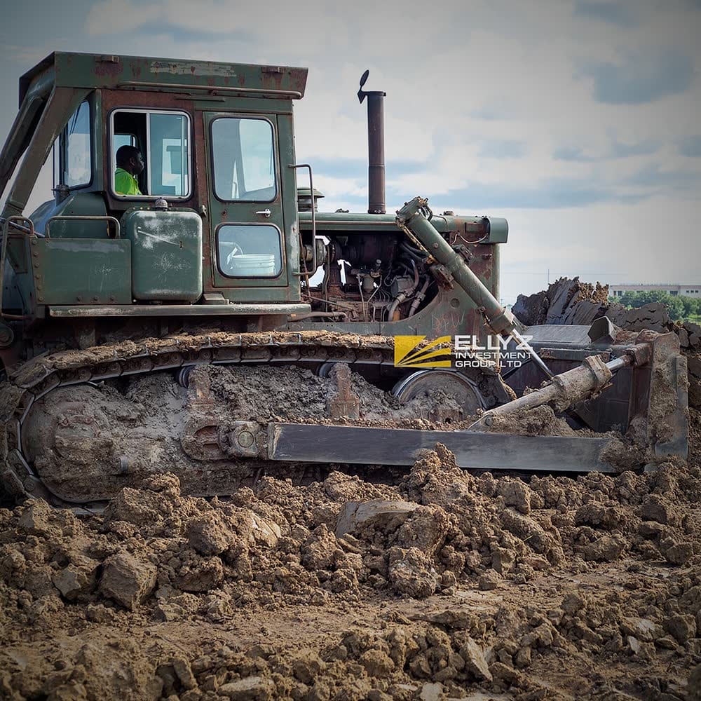 Ellyz bulldozer pushing soil with its blade, operator at the controls